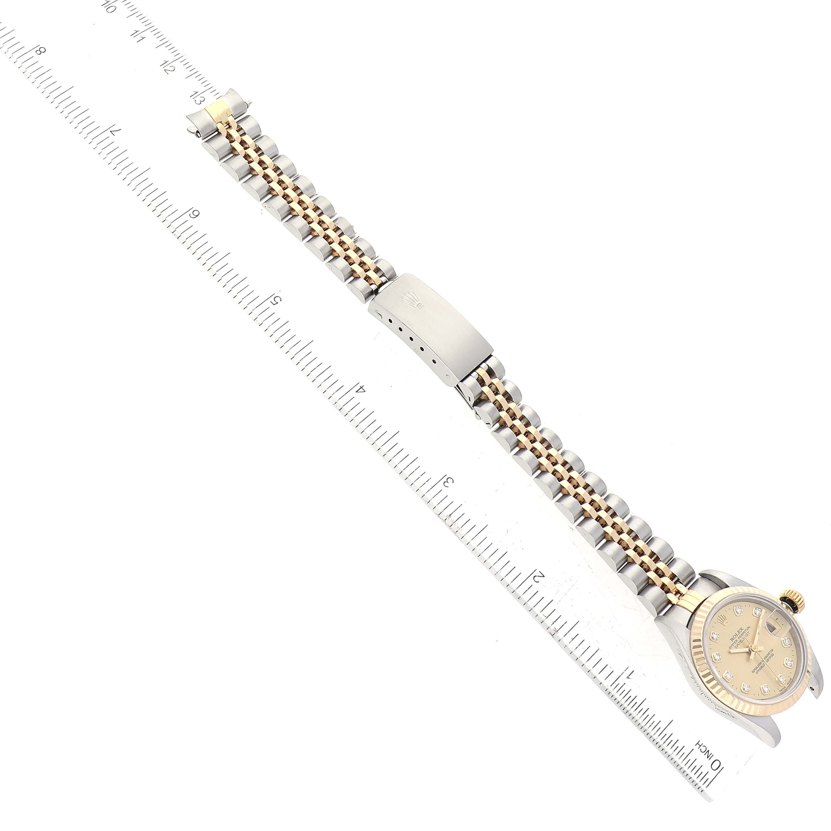 The image shows a top-down view of a Rolex Datejust 69173 Women's Steel and Gold (two tone) Champagne Dial 69173 Women's Steel and Gold (two tone) Champagne Dial watch, highlighting the face, bezel, crown, and two-tone bracelet with a clasp.