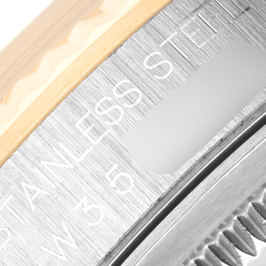 The image shows a close-up of the bezel and part of the stainless steel case of a Rolex Datejust 16233 Men's Steel and Gold (two tone) Grey Dial 16233 Men's Steel and Gold (two tone) Grey Dial watch.