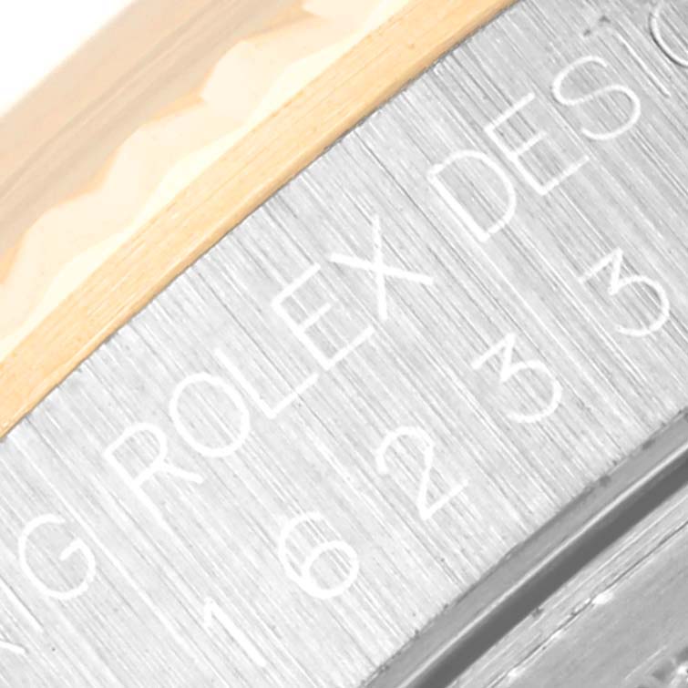 This close-up image shows the engraved model number and bezel edge of the Rolex Datejust 16233 Men's Steel and Gold (two tone) Grey Dial 16233 Men's Steel and Gold (two tone) Grey Dial watch.