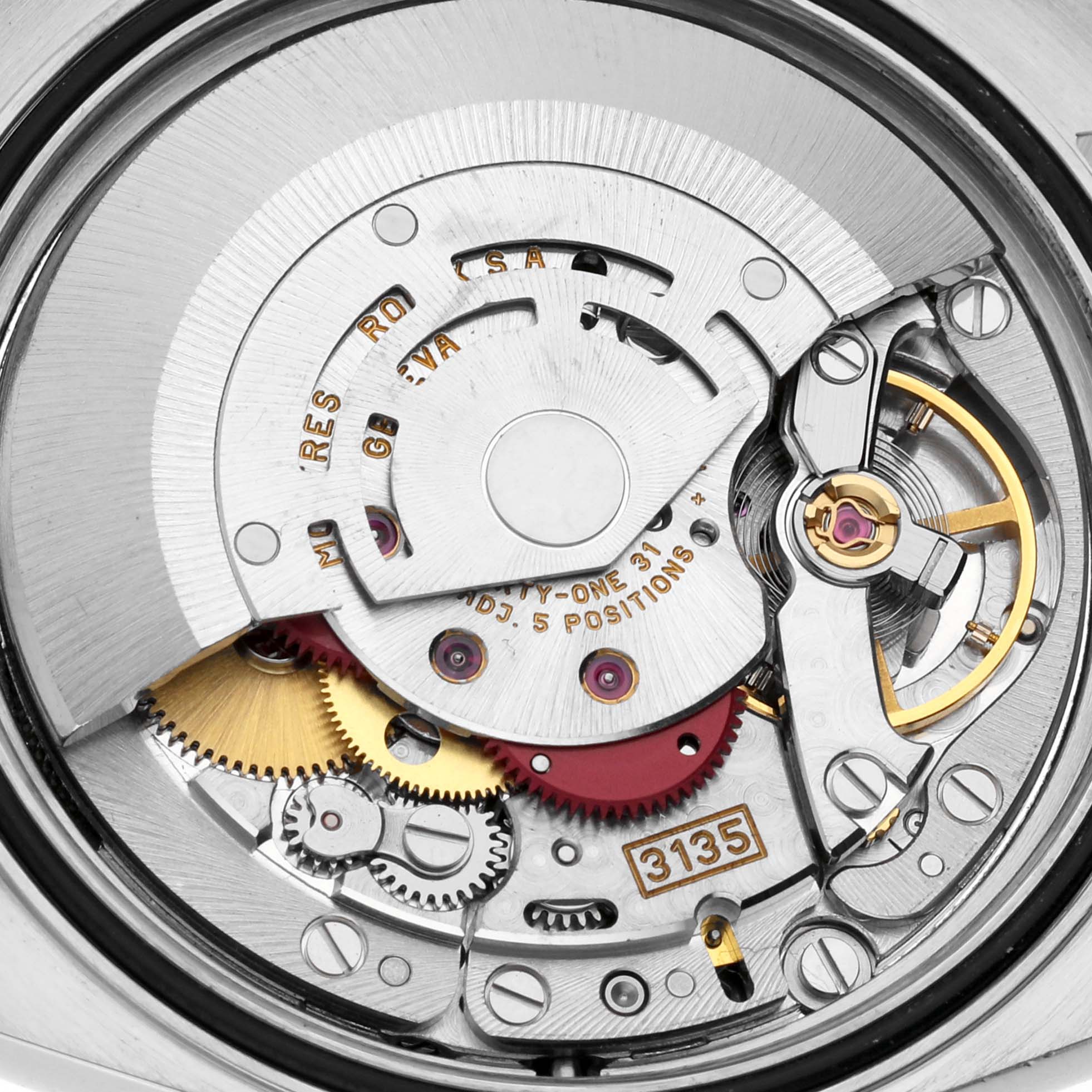 This is a close-up view of the Rolex Datejust 16233 Men's Steel and Gold (two tone) Grey Dial 16233 Men's Steel and Gold (two tone) Grey Dial watch's internal mechanism, specifically showing its movement components.