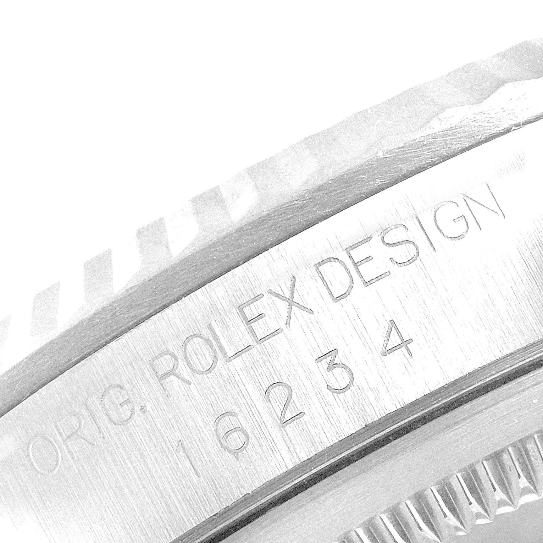 A close-up view of the side of a Rolex Datejust 16234 Men's Stainless Steel Mother of Pearl Dial 16234 Men's Stainless Steel Mother of Pearl Dial watch, showing the engraved model number and fluted bezel.