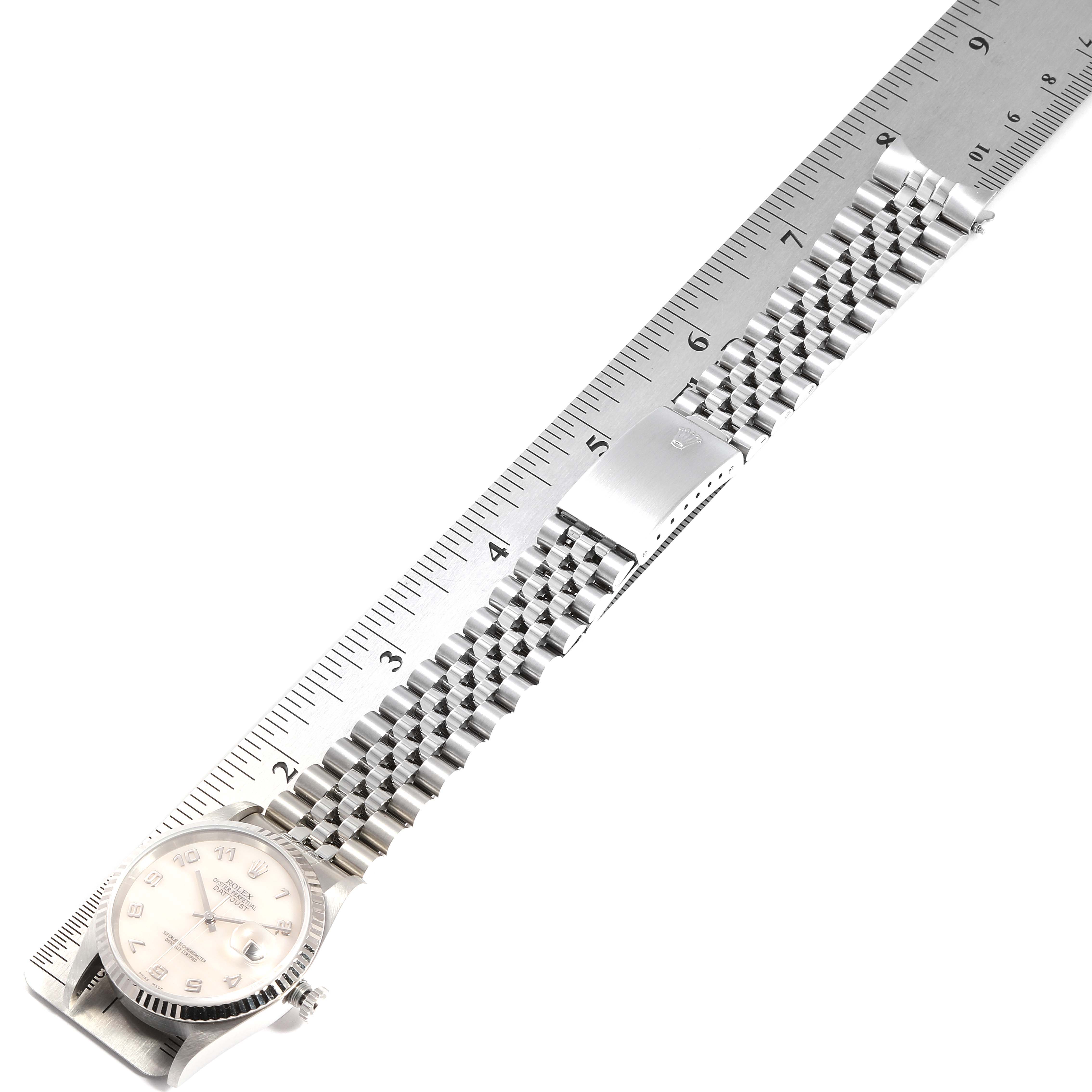 The image shows a Rolex Datejust 16234 Men's Stainless Steel Mother of Pearl Dial 16234 Men's Stainless Steel Mother of Pearl Dial watch laid flat with the bracelet and dial alongside a ruler.