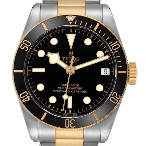 The Tudor Heritage Black Bay 79733 Men's Steel and Gold (two tone) Black Dial watch is shown from a front angle, displaying the dial, bezel, and part of the bracelet.