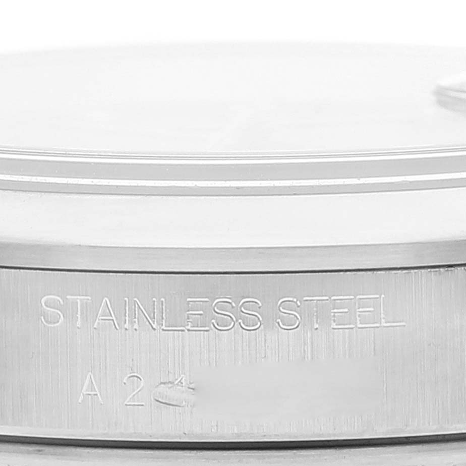 The image shows a close-up of the side of a stainless steel casing for a Rolex Date 15200 Men's Stainless Steel Pink Dial 15200 Men's Stainless Steel Pink Dial model watch, highlighting the engravings.