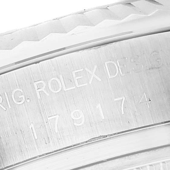 This close-up image shows the engraved serial number and "Rolex Design" text on the Rolex Datejust 179174 Women's Stainless Steel Mother of Pearl Dial 179174 Women's Stainless Steel Mother of Pearl Dial watch case.