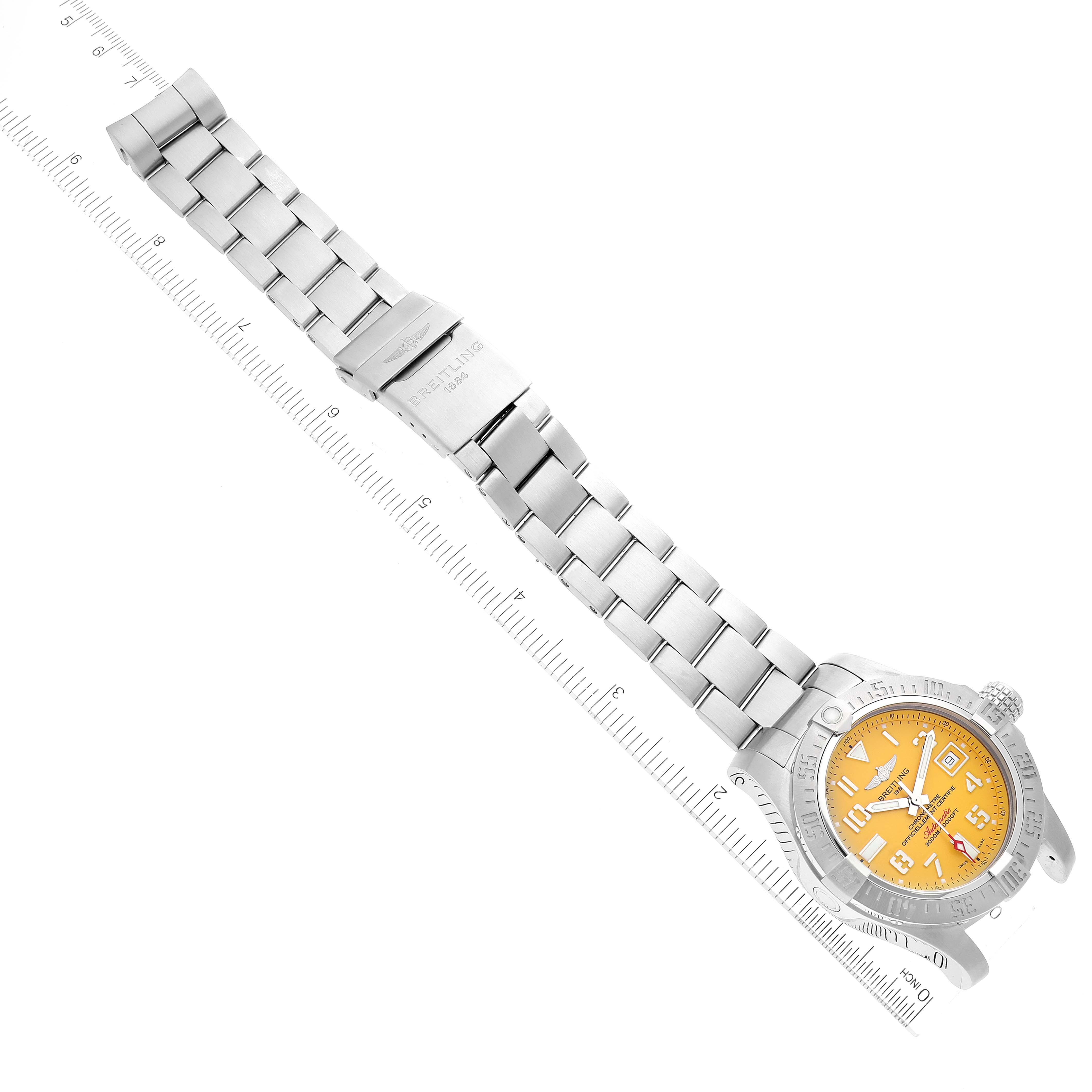 The image shows a top-down view of a Breitling Avenger A17331 Men's Stainless Steel Yellow Dial A17331 Men's Stainless Steel Yellow Dial watch, including its stainless steel bracelet, clasp, and orange dial.