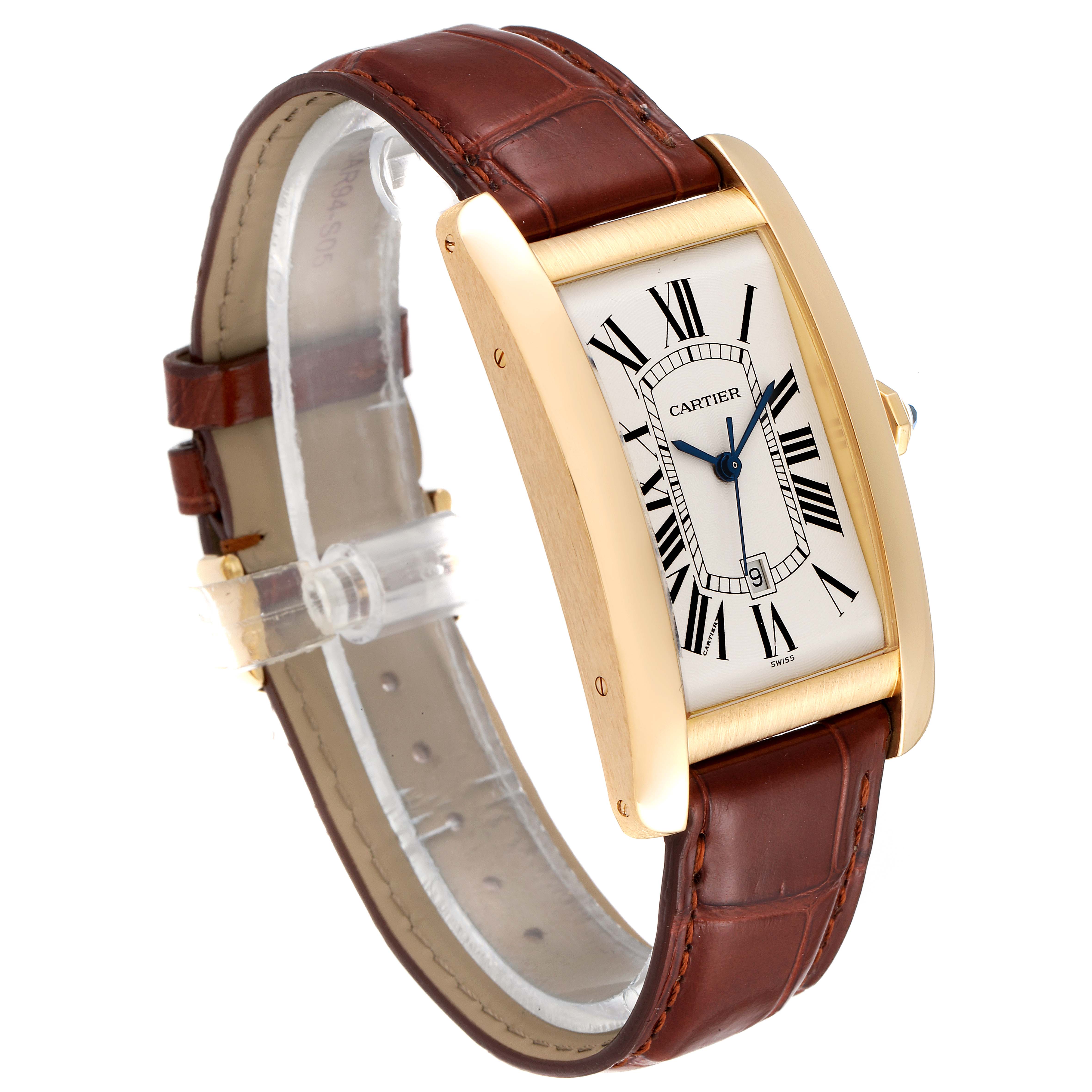 This Cartier Tank Americaine W2603156 Men's Yellow Gold Silver Dial W2603156 Men's Yellow Gold Silver Dial watch is shown at an angle highlighting its gold case, Roman numeral dial, and brown leather strap.