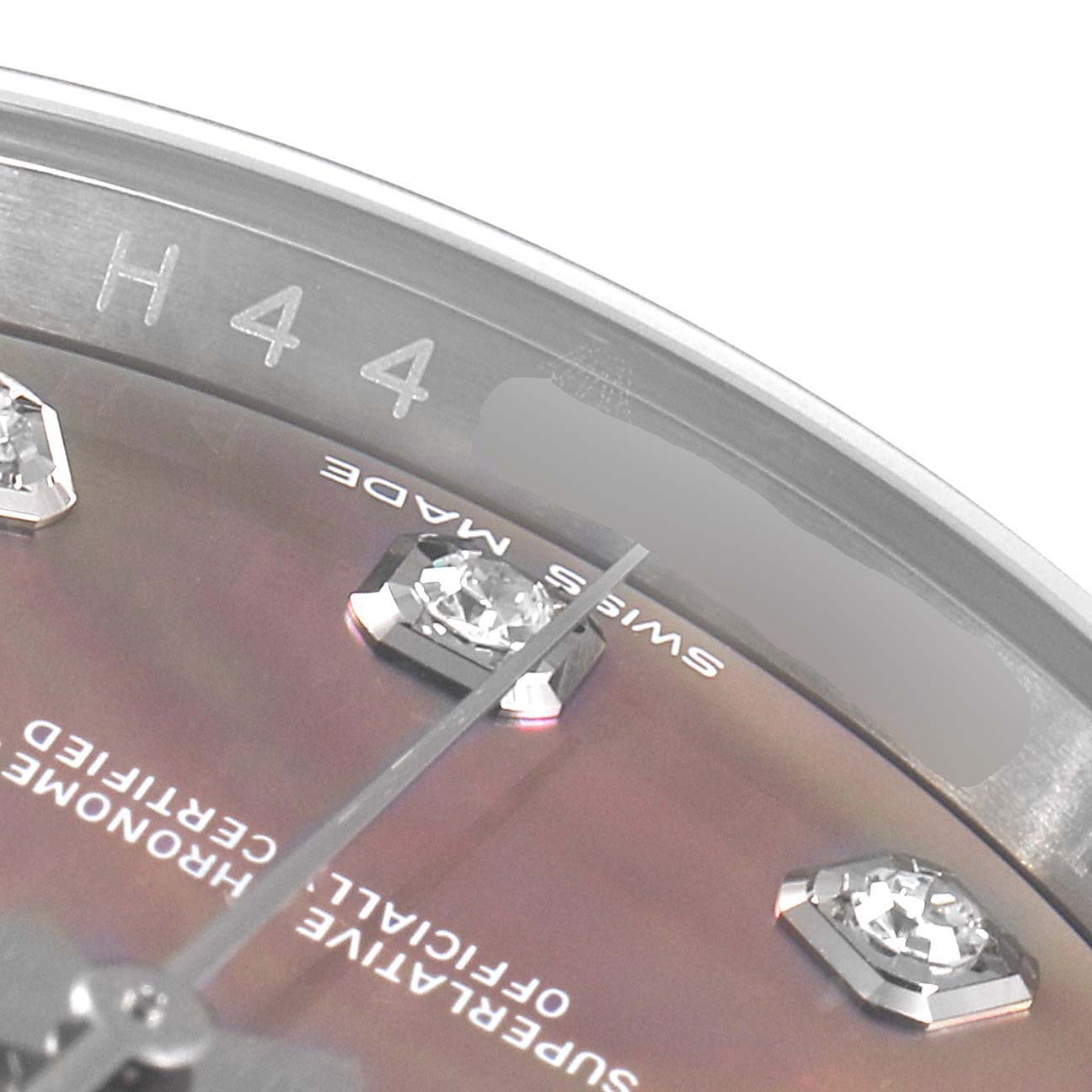 This close-up of a Rolex Datejust 116234 Men's Stainless Steel Mother of Pearl Dial 116234 Men's Stainless Steel Mother of Pearl Dial shows parts of the bezel, dial, and diamond-studded markers at an angle.