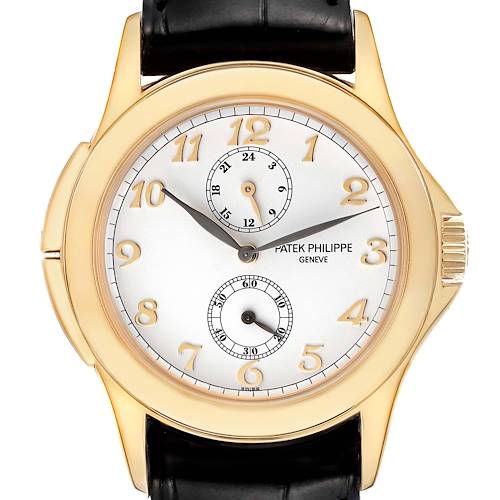 The image shows a close-up of the face of a Patek Philippe Calatrava 5134J Men's Yellow Gold White Dial 5134J Men's Yellow Gold White Dial watch, featuring gold numerals, subdials, and a black leather strap.