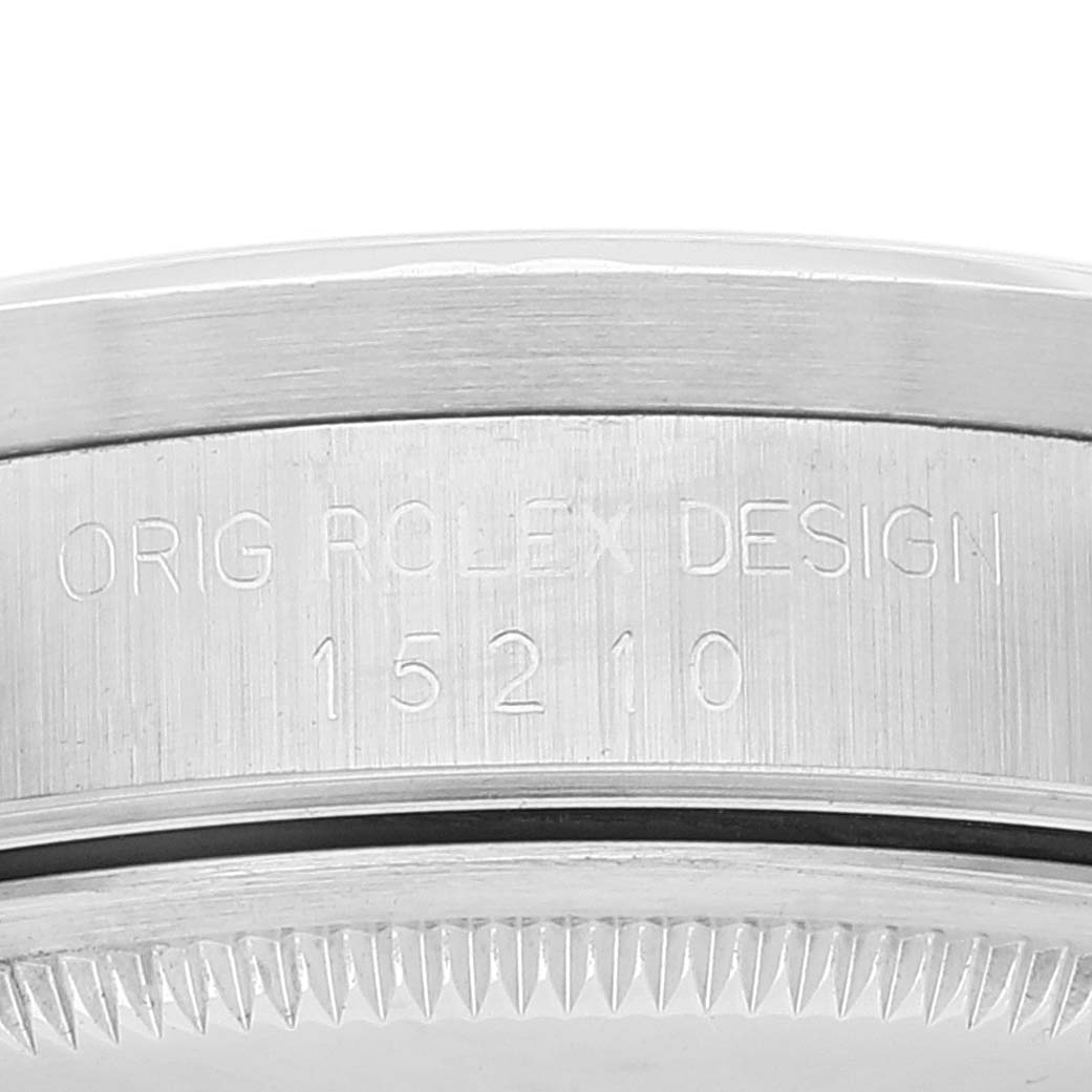 This image shows a close-up of the side of a Rolex Date 15210 Men's Stainless Steel Silver Dial 15210 Men's Stainless Steel Silver Dial model watch featuring its case with the model number engraved.