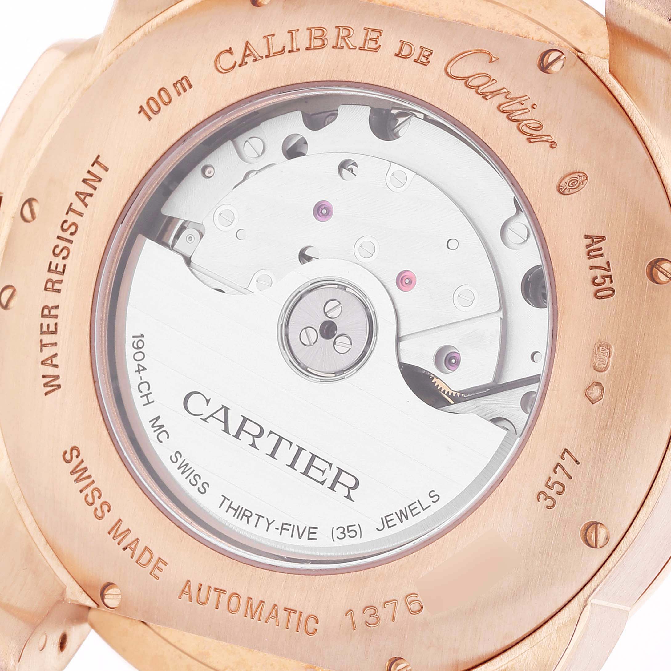 The image shows the back of a Calibre de Cartier watch, highlighting its automatic movement and engravings.