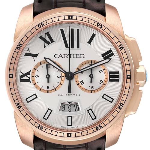 The image shows a frontal view of the Calibre de Cartier watch, highlighting its dial, subdials, and date window.