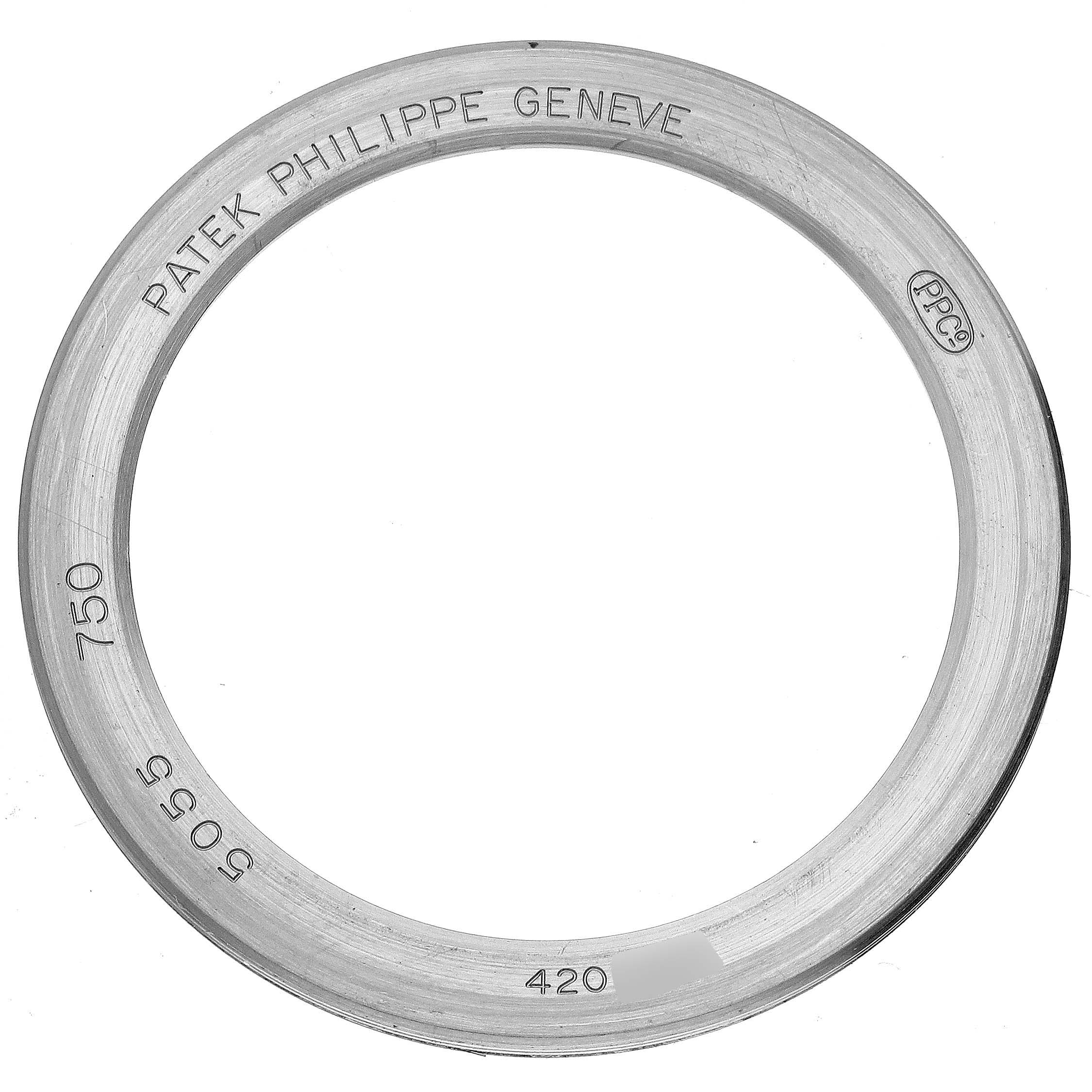 This image shows the bezel ring of a Patek Philippe Complications 5055G-010 Men's White Gold Black Dial 5055G-010 Men's White Gold Black Dial watch viewed from above.