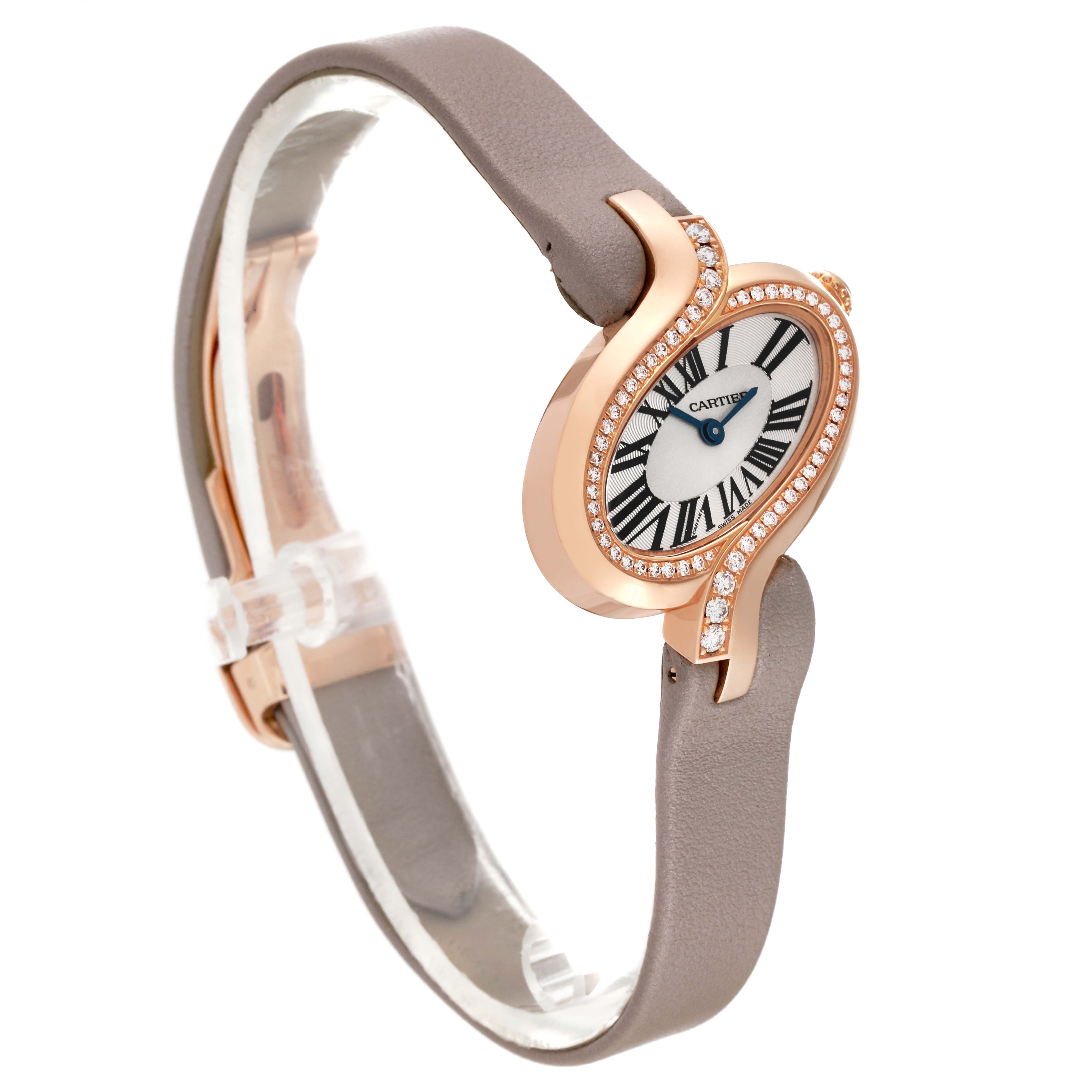 The image shows a side view of a Cartier Delices WG800013 Women's Rose Gold Silver Dial WG800013 Women's Rose Gold Silver Dial watch, highlighting its brown strap and diamond-studded, oval-shaped case.