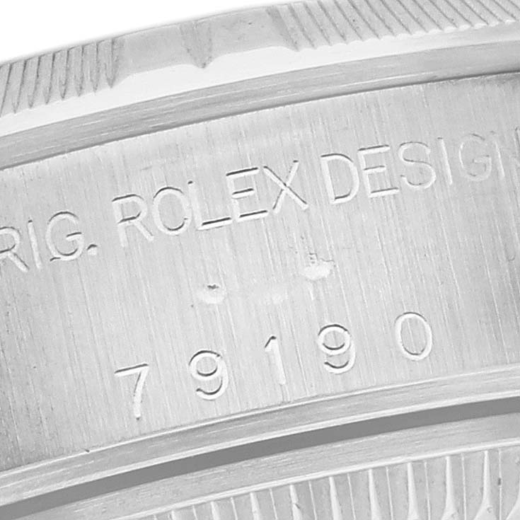 The image shows a close-up of the side engraving on a Rolex Date 79190 Women's Stainless Steel White Dial 79190 Women's Stainless Steel White Dial model watch, displaying the serial number and design details.