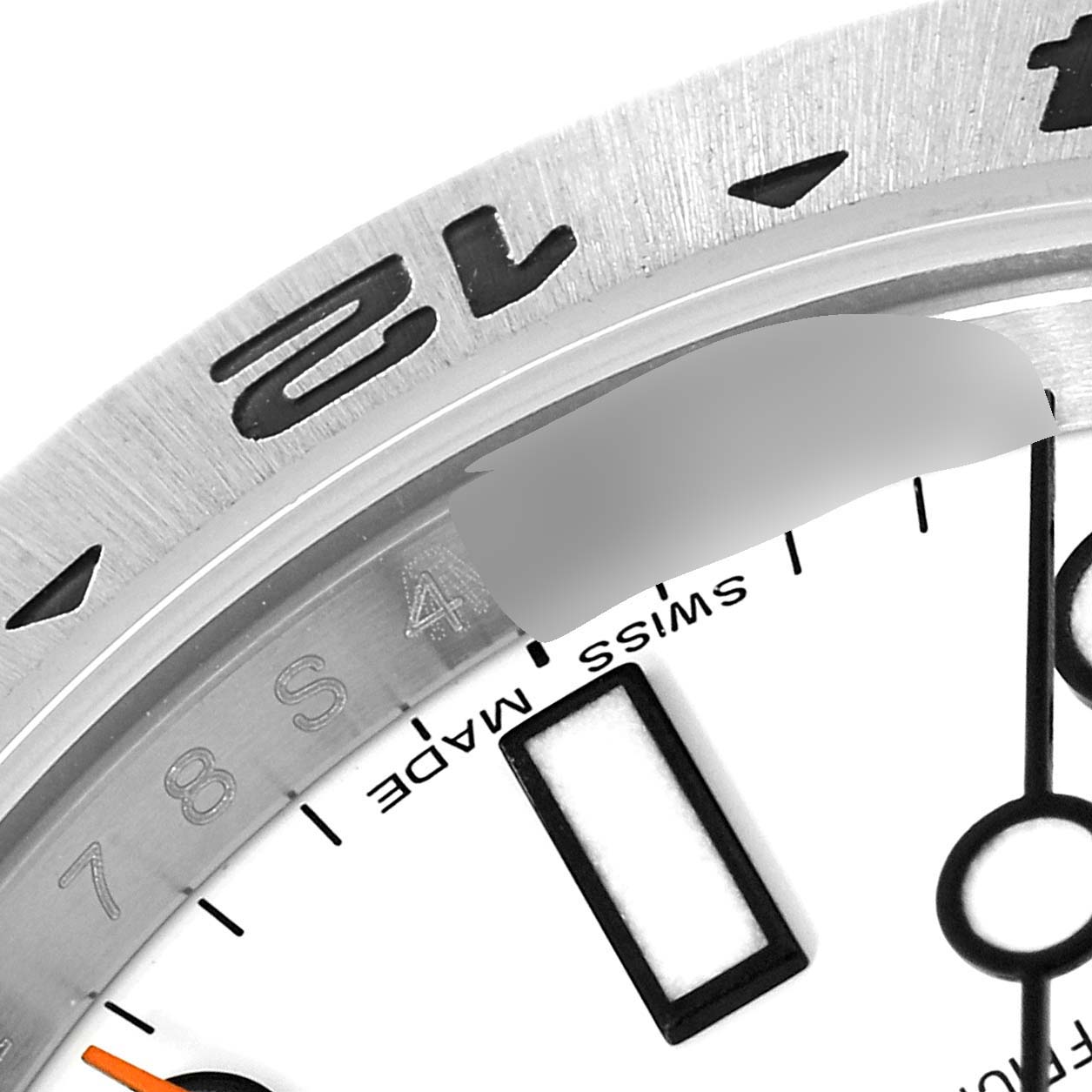 This close-up image shows the bezel, part of the dial, and indices of a Rolex Explorer 216570 Men's Stainless Steel White Dial 216570 Men's Stainless Steel White Dial watch.