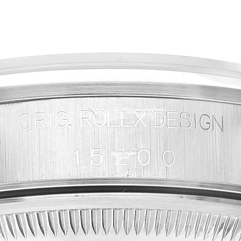 The image shows a close-up of the side of a Rolex Date 15200 Men's Stainless Steel Pink Dial 15200 Men's Stainless Steel Pink Dial model watch case, engraved with "ORIG. ROLEX DESIGN 15200."