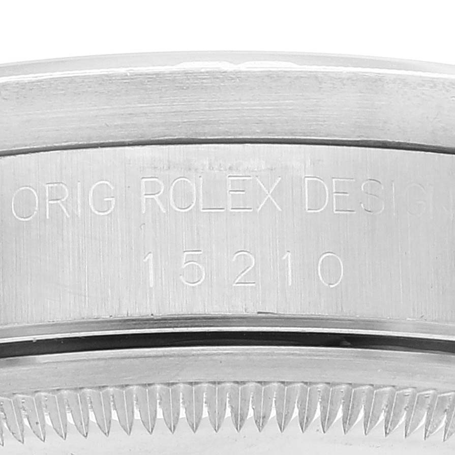 This image shows a close-up of the side of a Rolex Date 15210 Men's Stainless Steel White Dial 15210 Men's Stainless Steel White Dial model watch, focusing on the engraved design number 15210.