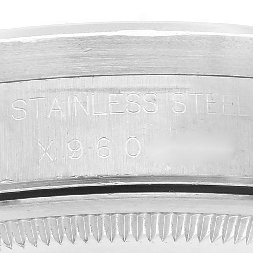 This image shows a close-up of the engraved serial number and "STAINLESS STEEL" text on the casing of a Rolex Date 15210 Men's Stainless Steel White Dial 15210 Men's Stainless Steel White Dial model watch.