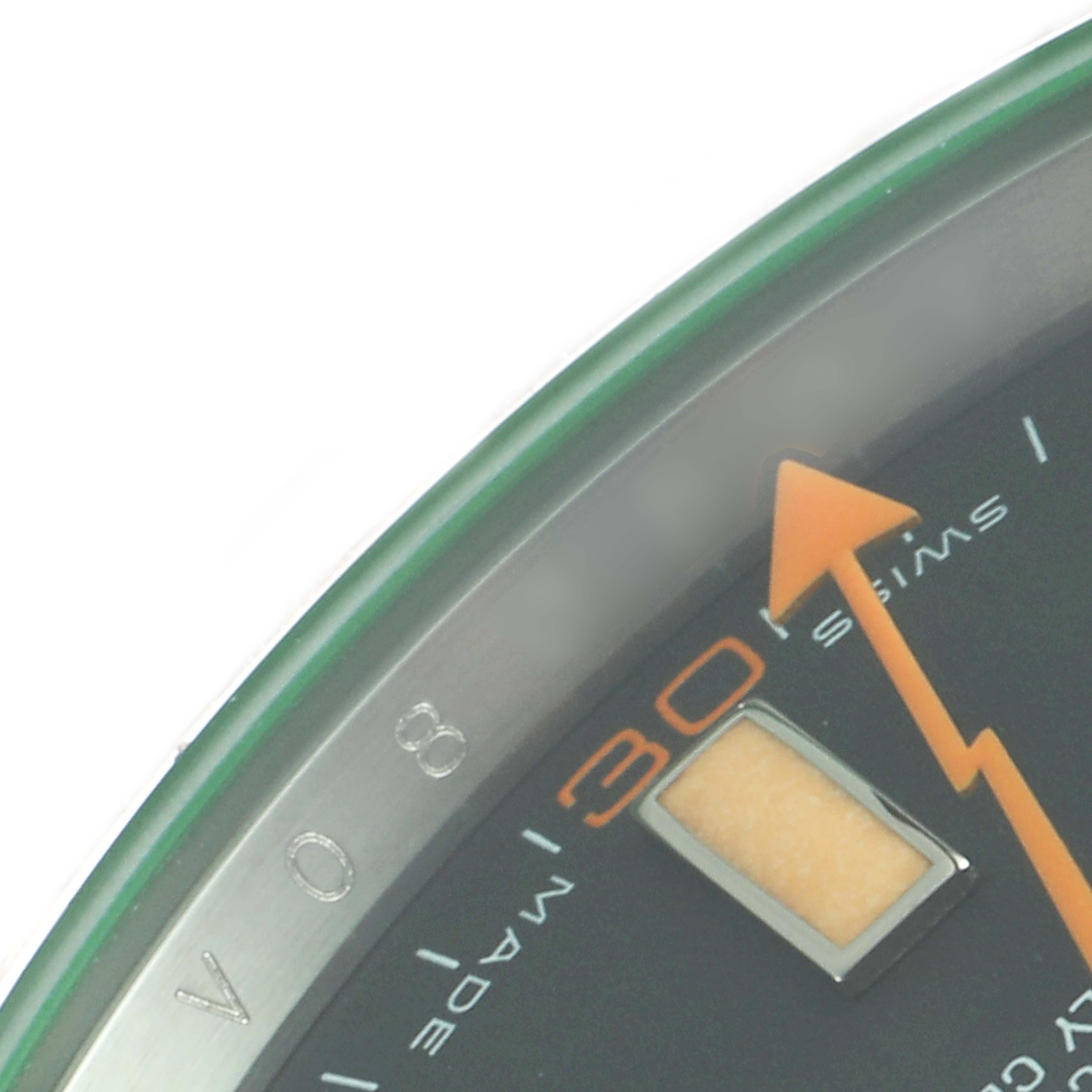 The image shows a close-up of the dial of a Rolex Milgauss 116400GV Men's Stainless Steel Black Dial 116400GV Men's Stainless Steel Black Dial watch, highlighting part of the minute markers and the orange lightning bolt second hand.