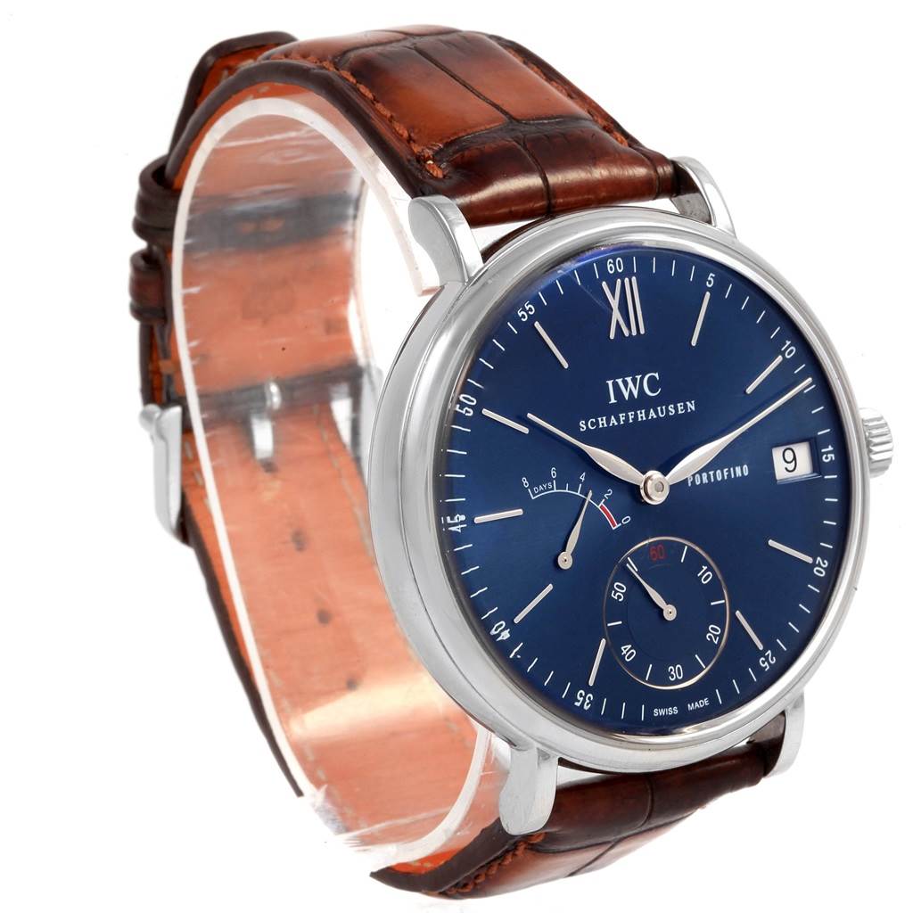 This image shows a close-up, angled view of the IWC Portofino IW510106 Men's Stainless Steel Blue Dial IW510106 Men's Stainless Steel Blue Dial watch, highlighting its blue dial, date display, subdials, and brown leather strap.