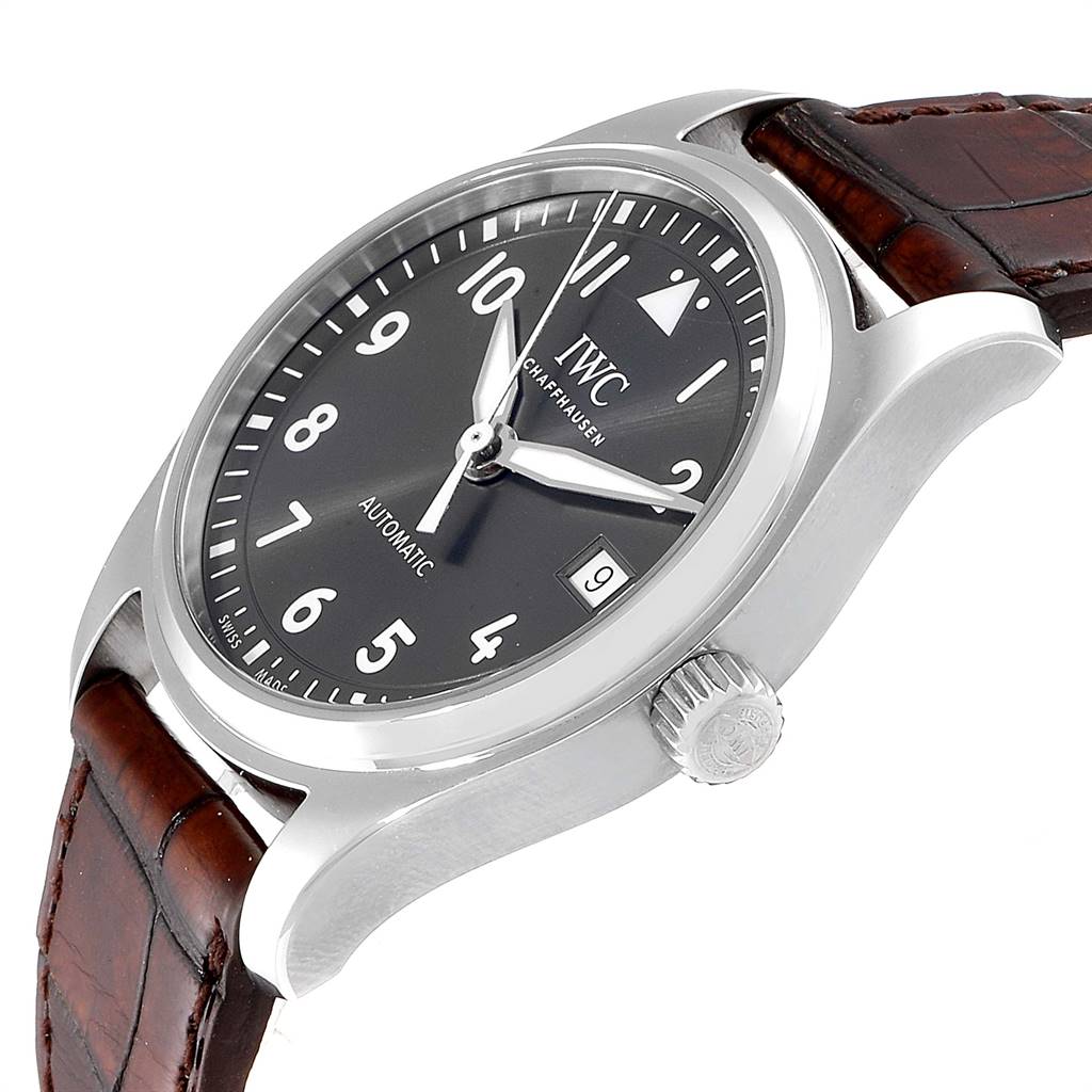 The image shows an IWC Pilot 5524G Men's Stainless Steel Grey Dial 5524G Men's Stainless Steel Grey Dial model watch at an angled view, highlighting its dial, crown, and leather strap.