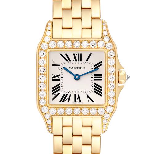 The Cartier Santos Demoiselle WF9002Y7 Women's Yellow Gold Silver Dial WF9002Y7 Women's Yellow Gold Silver Dial watch is shown from a top-down angle, highlighting its diamond-studded bezel, face, and part of its gold bracelet.