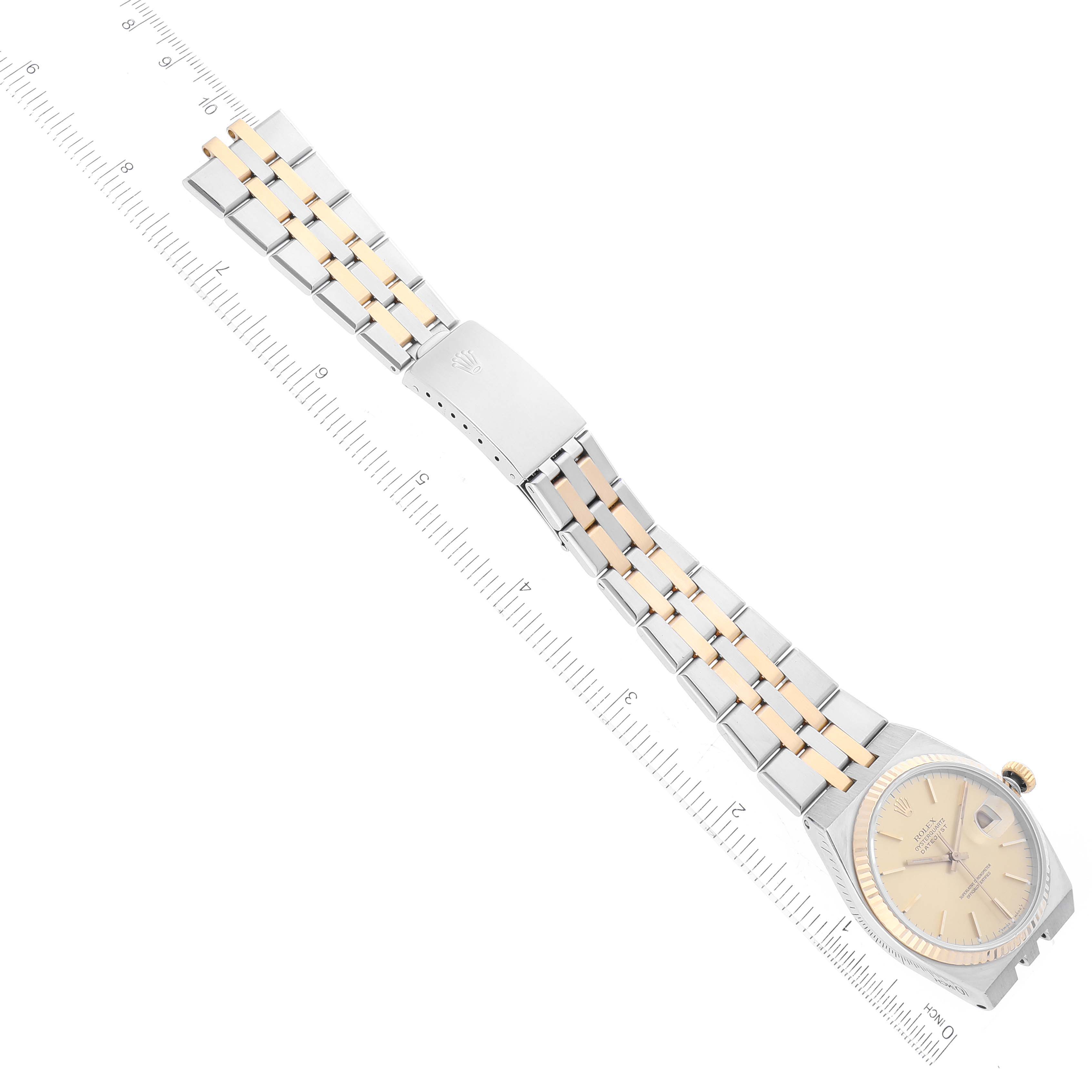 The image shows a top view of a Rolex Oysterquartz 17013 Men's Steel and Gold (two tone) Champagne Dial 17013 Men's Steel and Gold (two tone) Champagne Dial watch with its case, dial, and bracelet visible, placed alongside a ruler.