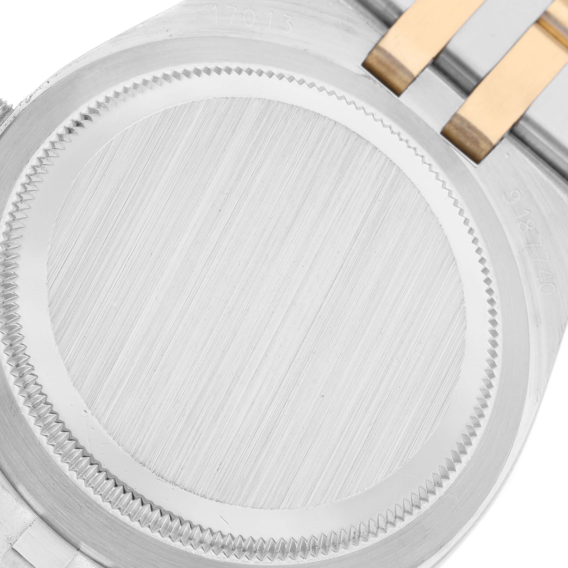 This image shows the back case of a Rolex Oysterquartz 17013 Men's Steel and Gold (two tone) Champagne Dial 17013 Men's Steel and Gold (two tone) Champagne Dial watch, focusing on its silver and gold detailing.