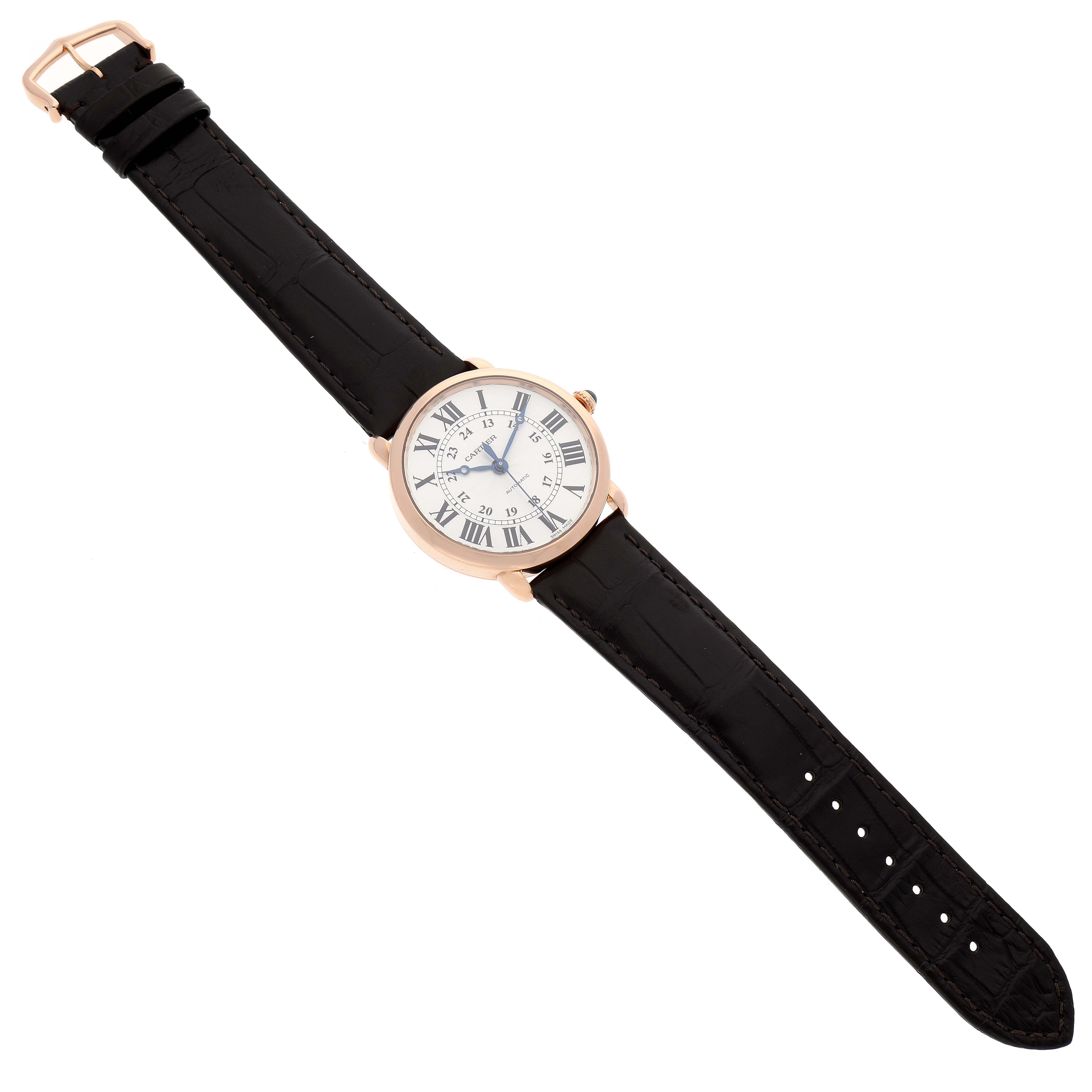 The image shows a top view of the Cartier Ronde WGRN0006 Men's Rose Gold Silver Dial WGRN0006 Men's Rose Gold Silver Dial model watch, displaying its black strap and white dial with Roman numerals.