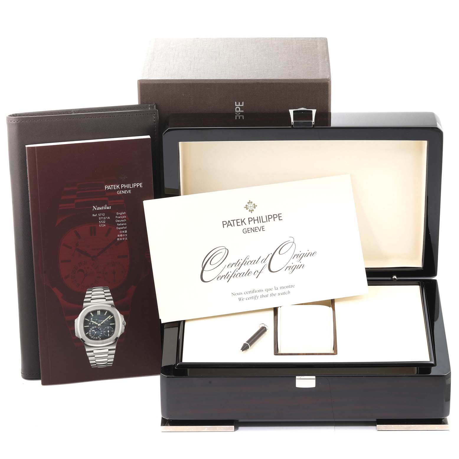 This image shows a Patek Philippe Nautilus 5712/1A-001 Men's Stainless Steel Blue Dial 5712/1A-001 Men's Stainless Steel Blue Dial watch box, accompanying documents, and a certificate of origin from an aerial perspective.