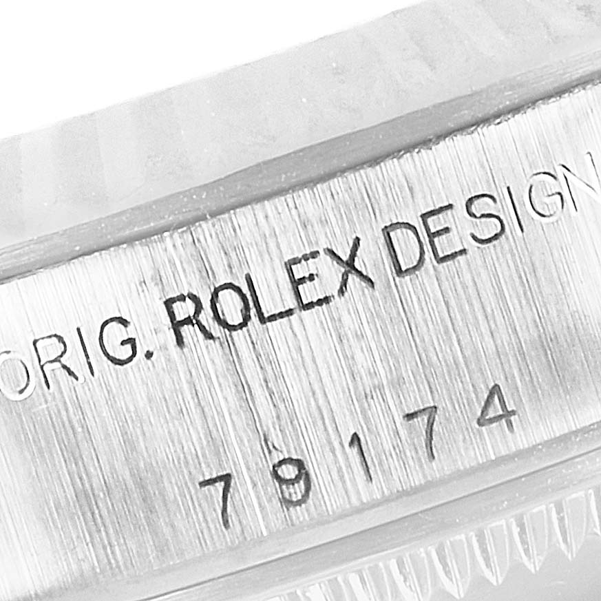 Close-up of the case side displaying the "ORIG. ROLEX DESIGN" engraving and part of the serial number of a Rolex Datejust 79174 Women's Stainless Steel Mother of Pearl Dial 79174 Women's Stainless Steel Mother of Pearl Dial watch.