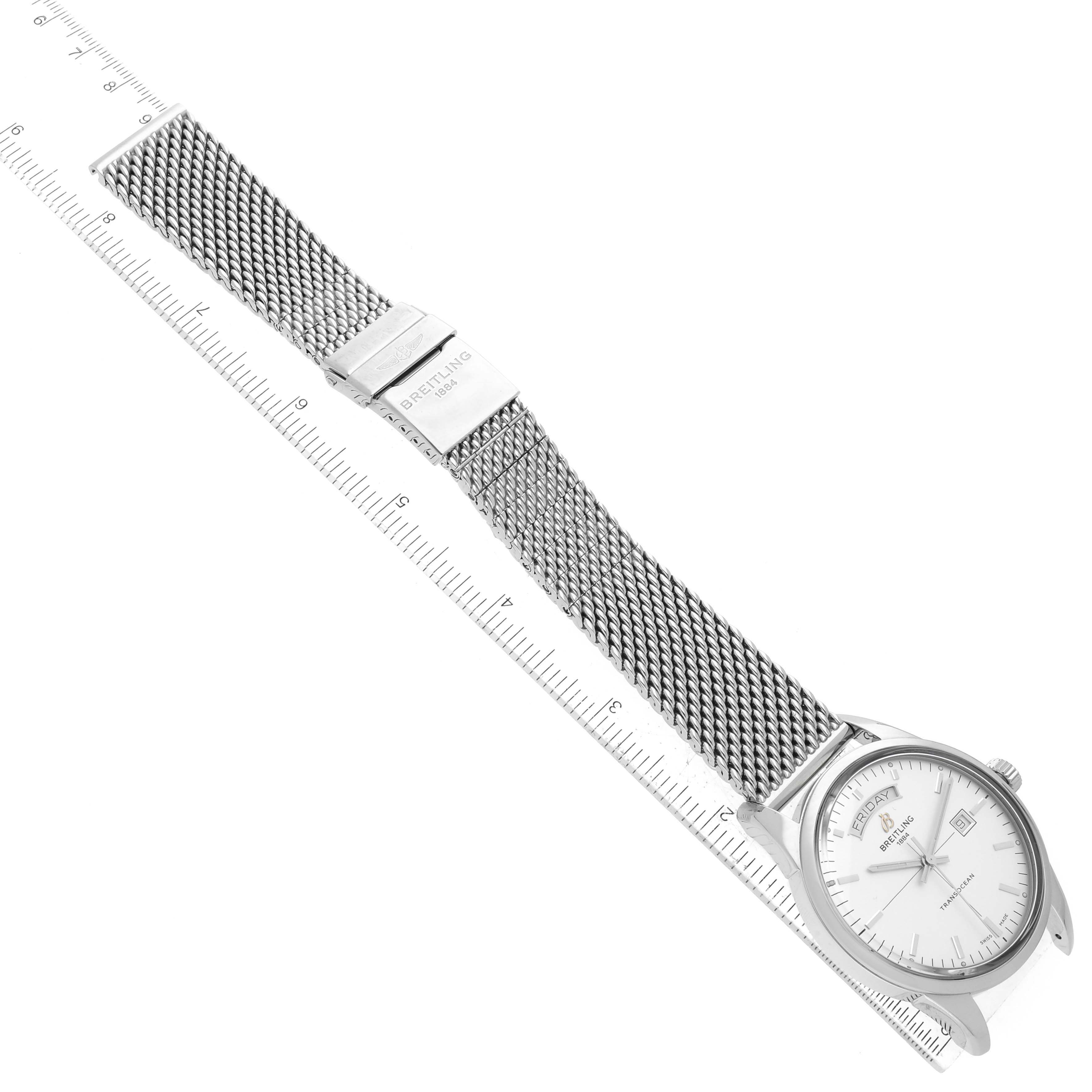The image shows a Breitling Transocean A45310 Men's Stainless Steel White Dial A45310 Men's Stainless Steel White Dial watch laying flat, displaying its mesh strap, clasp, and face alongside a ruler for scale.