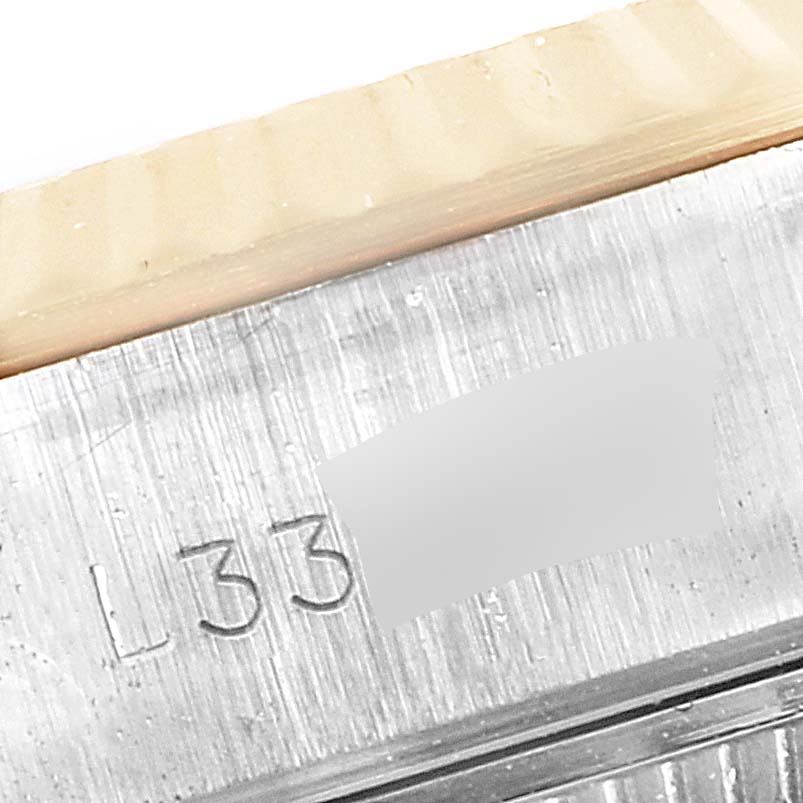 This image shows a close-up of the serial number engraving on the case of a Rolex Datejust 69173 Women's Steel and Gold (two tone) Black Dial 69173 Women's Steel and Gold (two tone) Black Dial watch.