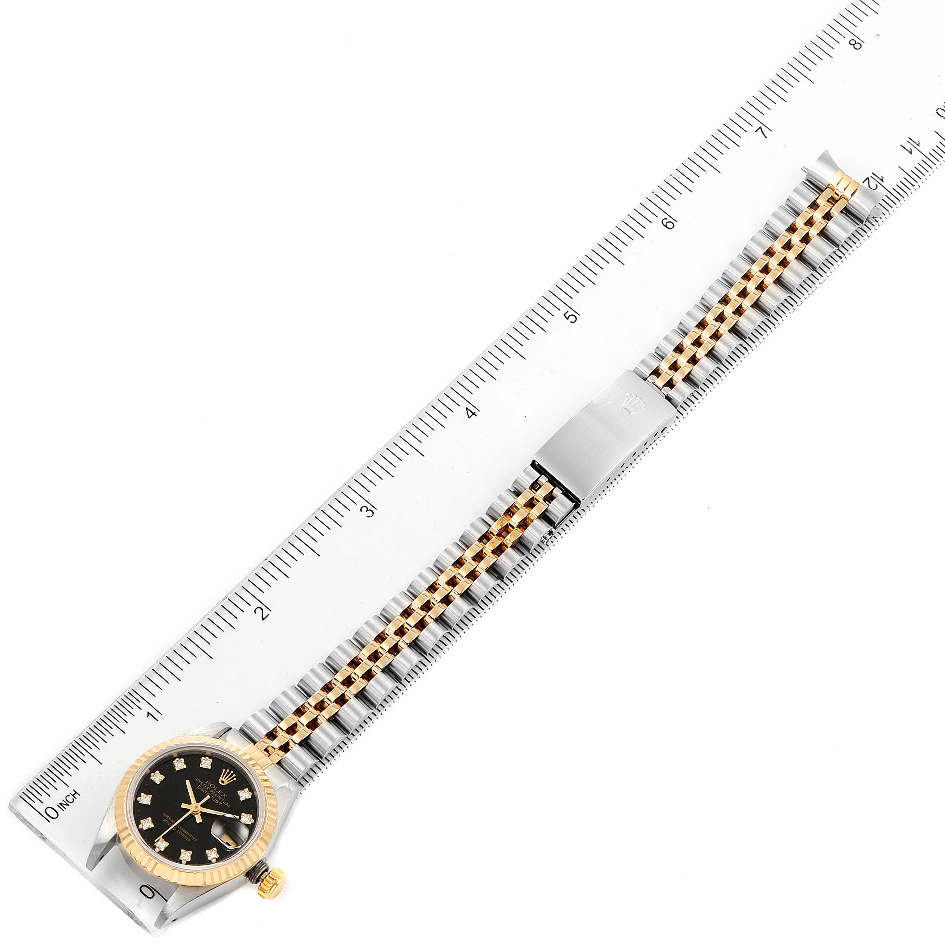 The image shows a Rolex Datejust 69173 Women's Steel and Gold (two tone) Black Dial 69173 Women's Steel and Gold (two tone) Black Dial watch from a top-down angle with a ruler for scale.