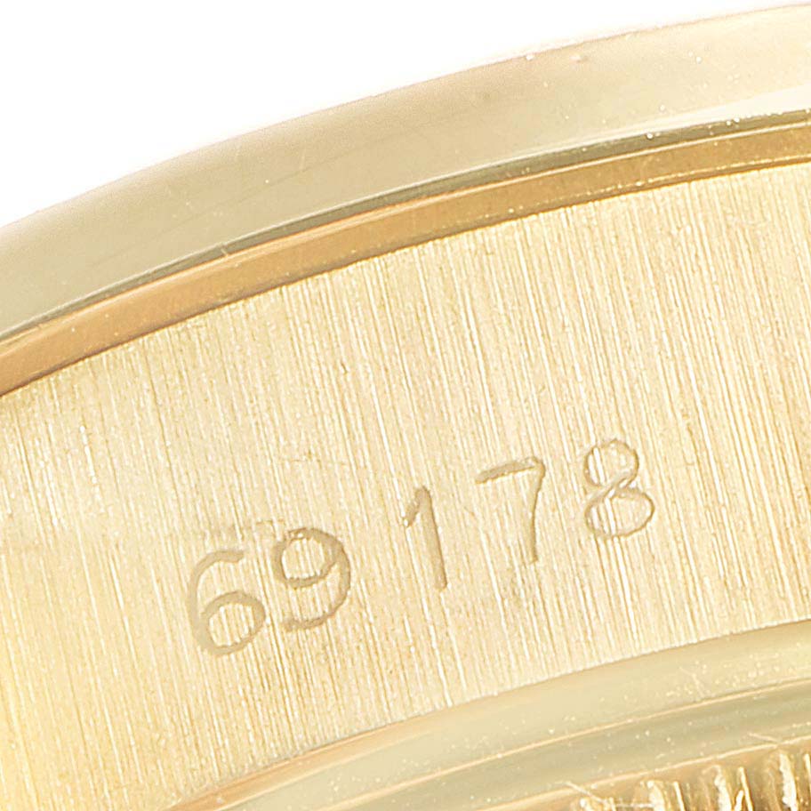 This close-up image shows the case back or interior of the case of a Rolex President 69178 Women's Yellow Gold Champagne Dial 69178 Women's Yellow Gold Champagne Dial model, featuring a serial number engraving.