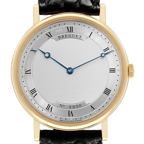 The Breguet Classique 5157BA Men's Yellow Gold Silver Dial watch is shown from the front, highlighting its gold case, guilloché dial, Roman numerals, and blued hands.