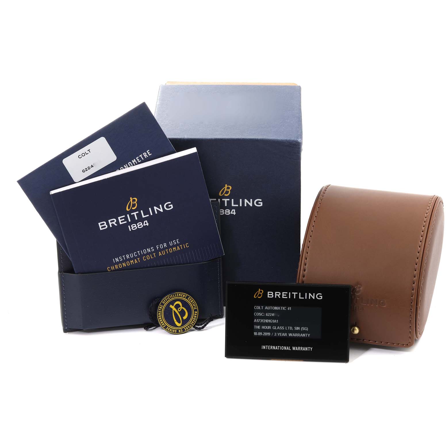 The image shows the Breitling Colt A17313 Men's Stainless Steel White Dial A17313 Men's Stainless Steel White Dial model watch packaging, manuals, warranty card, and a brown leather case.
