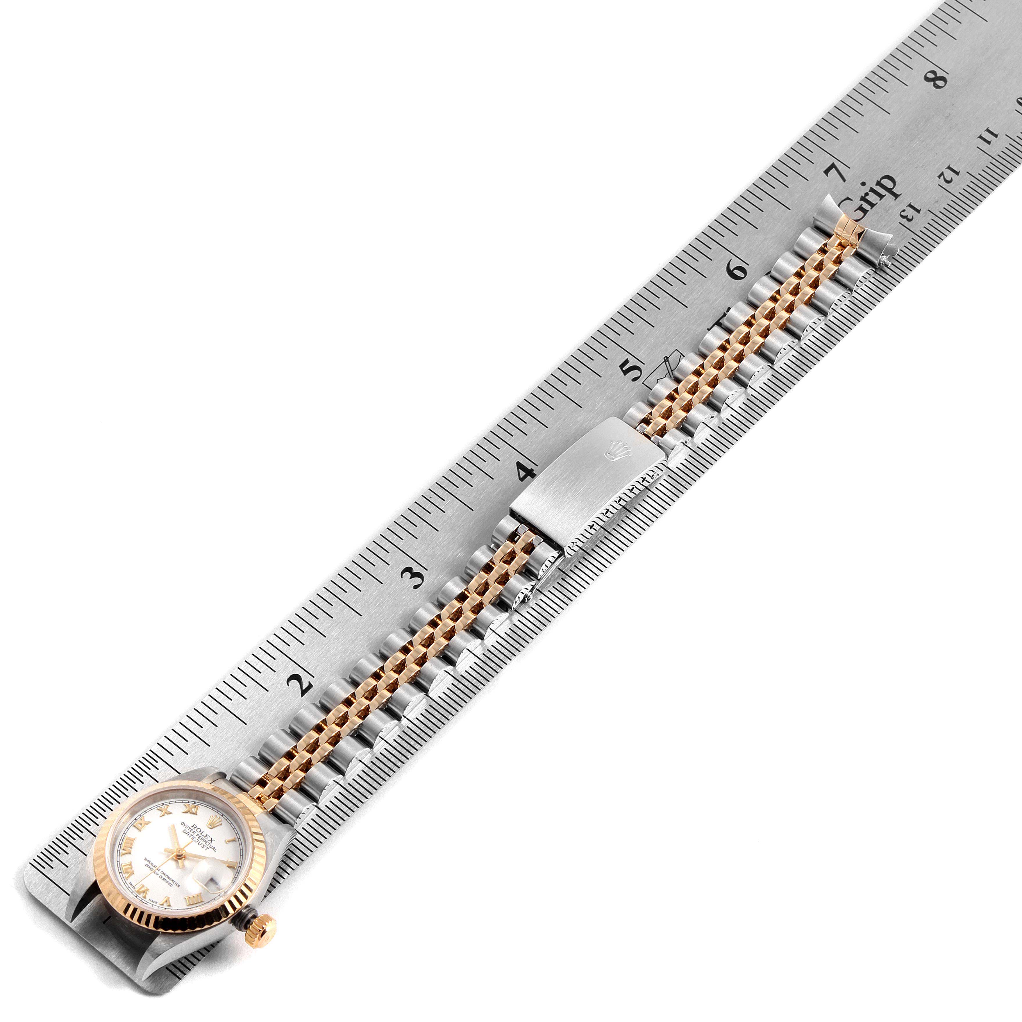The Rolex Datejust 79173 Women's Steel and Gold (two tone) White Dial 79173 Women's Steel and Gold (two tone) White Dial watch is shown from a top-down angle, with the face and band aligned along a ruler.
