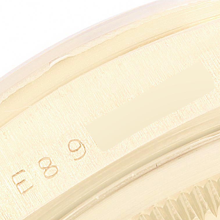 This is a close-up view of the inner bezel and part of the fluted bezel of a Rolex President 18248 Men's Yellow Gold Silver Dial 18248 Men's Yellow Gold Silver Dial model watch.