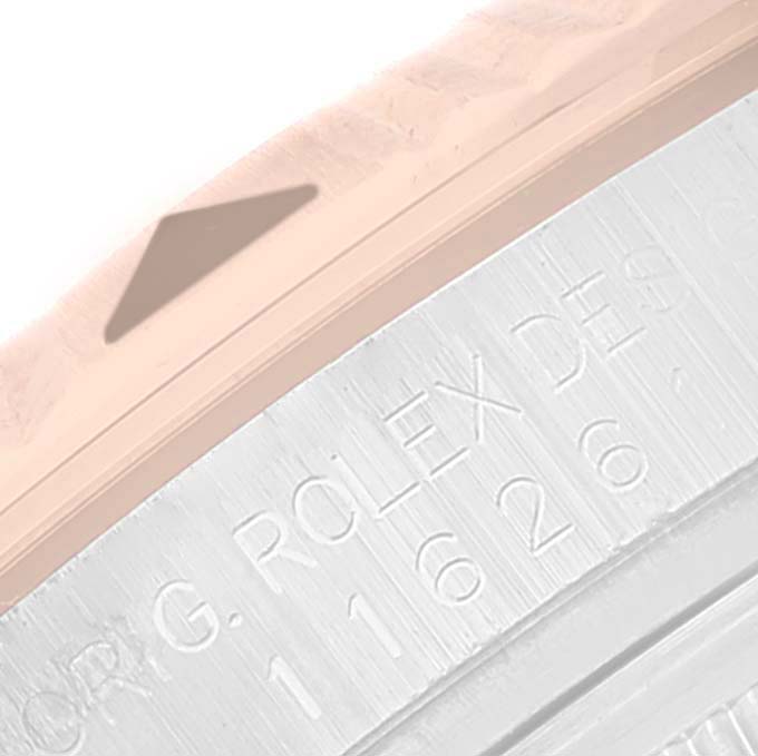 This close-up image of the Rolex Turn-o-Graph 116261 Men's Steel and Gold (two tone) White Dial 116261 Men's Steel and Gold (two tone) White Dial watch shows a portion of the bezel and part of the engraved inner ring.