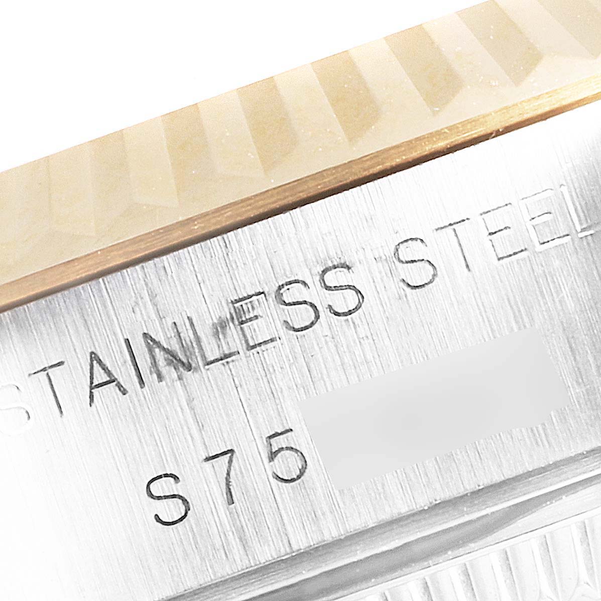 This close-up image shows the engraved stainless steel of the Rolex Datejust 69173 Women's Steel and Gold (two tone) White Dial 69173 Women's Steel and Gold (two tone) White Dial watch bezel.