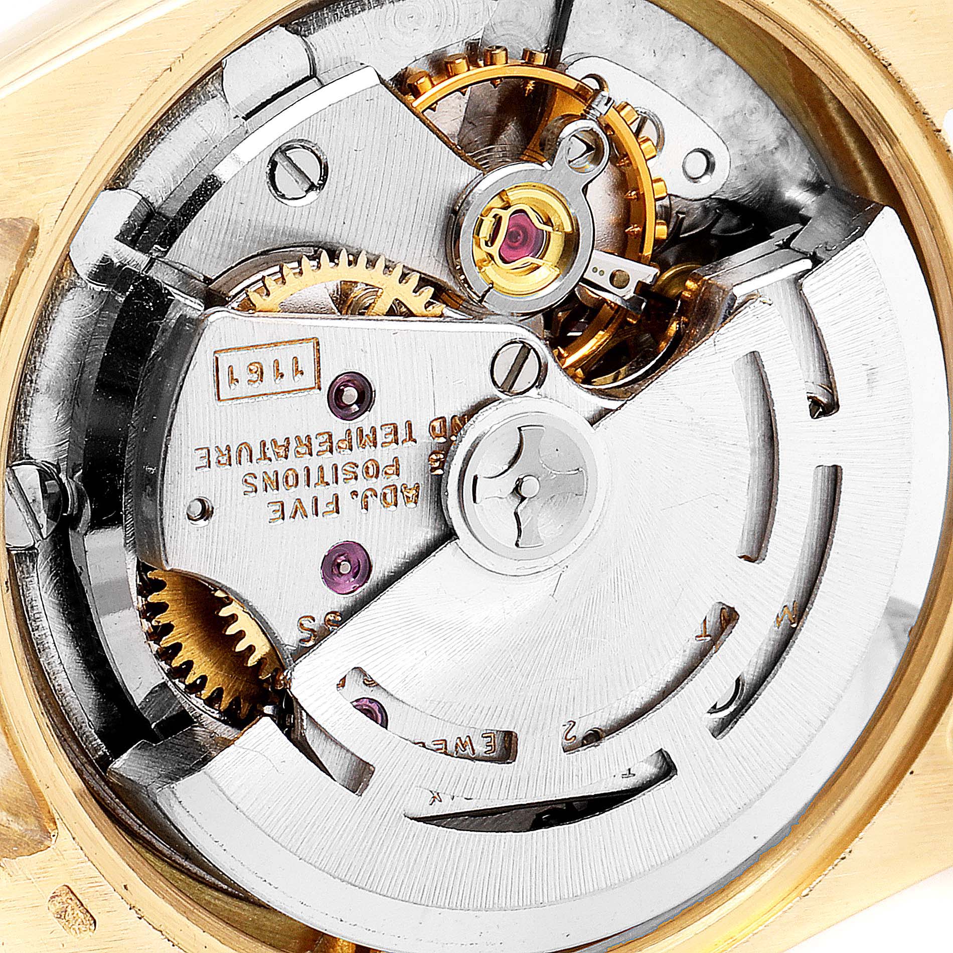 The image shows the internal mechanism of a Rolex Oyster Perpetual 6615 Women's Yellow Gold Silver Dial 6615 Women's Yellow Gold Silver Dial watch viewed from the back, highlighting gears and components.