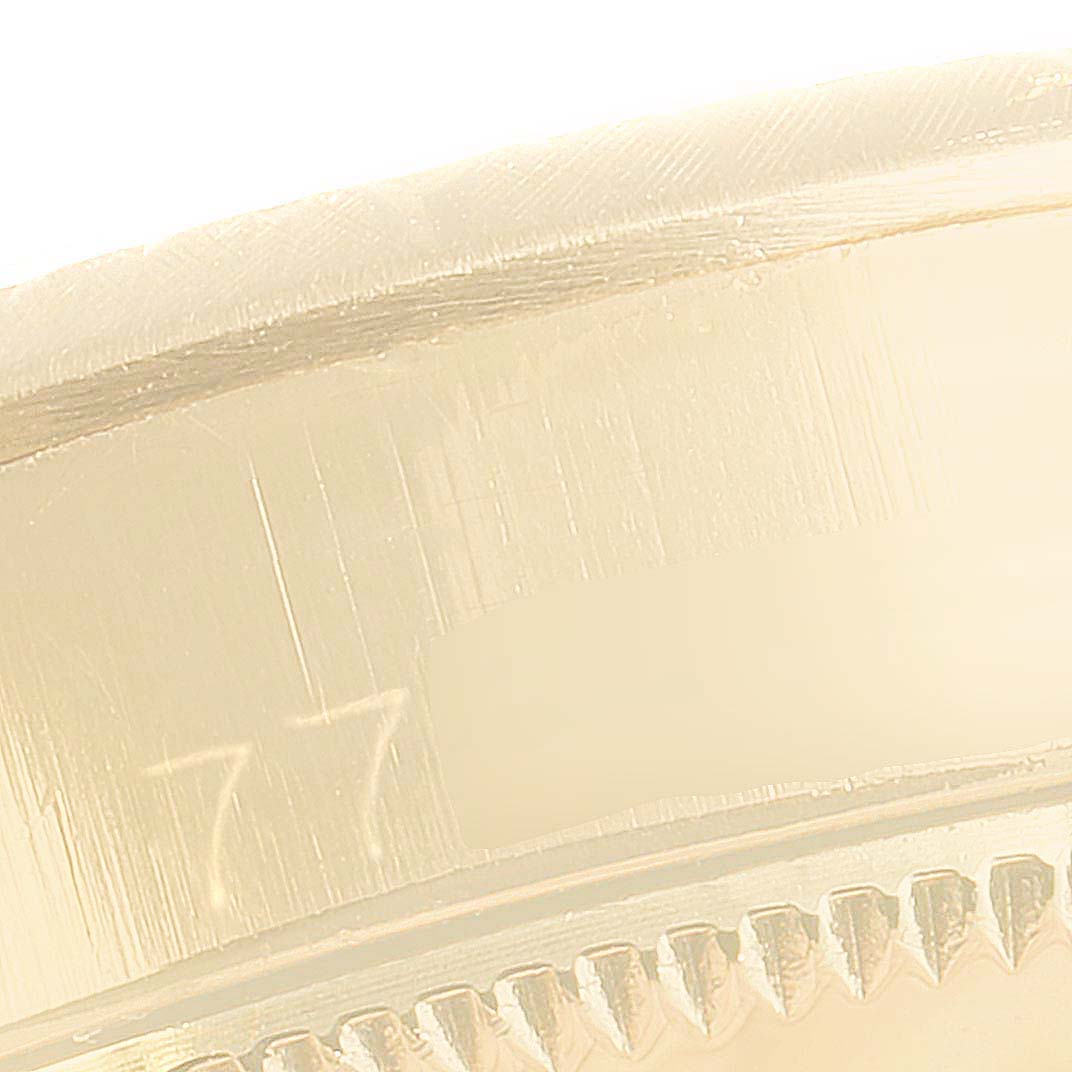 This close-up shows the side edge of a Rolex Oyster Perpetual 6615 Women's Yellow Gold Silver Dial 6615 Women's Yellow Gold Silver Dial watch case.