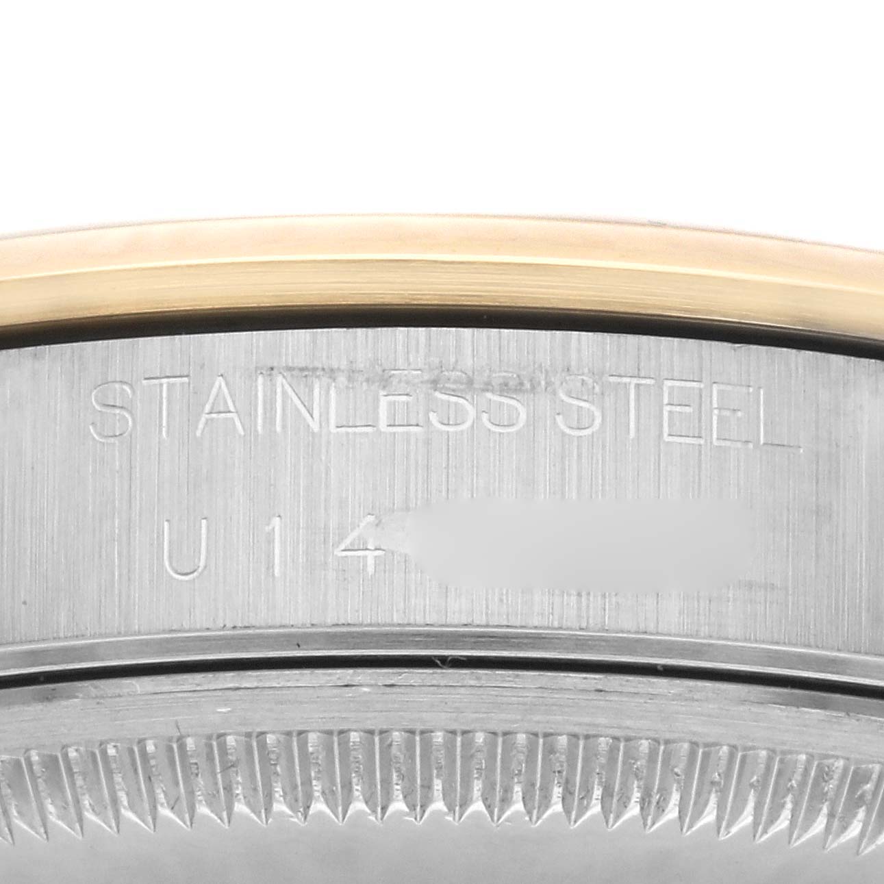 This close-up image shows the side engraving detail of a stainless steel Rolex Date 15203 Men's Steel and Gold (two tone) White Dial 15203 Men's Steel and Gold (two tone) White Dial watch model.