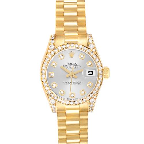 The Rolex President 179158 Women's Yellow Gold Silver Dial model watch is shown from a top-down angle, highlighting the gold bracelet, diamond bezel, and face details.
