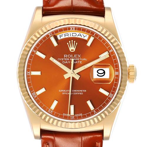 The Rolex President 118139 Men's Yellow Gold Orange Dial model is shown from a front angle, highlighting the dial, bezel, and brown leather strap.