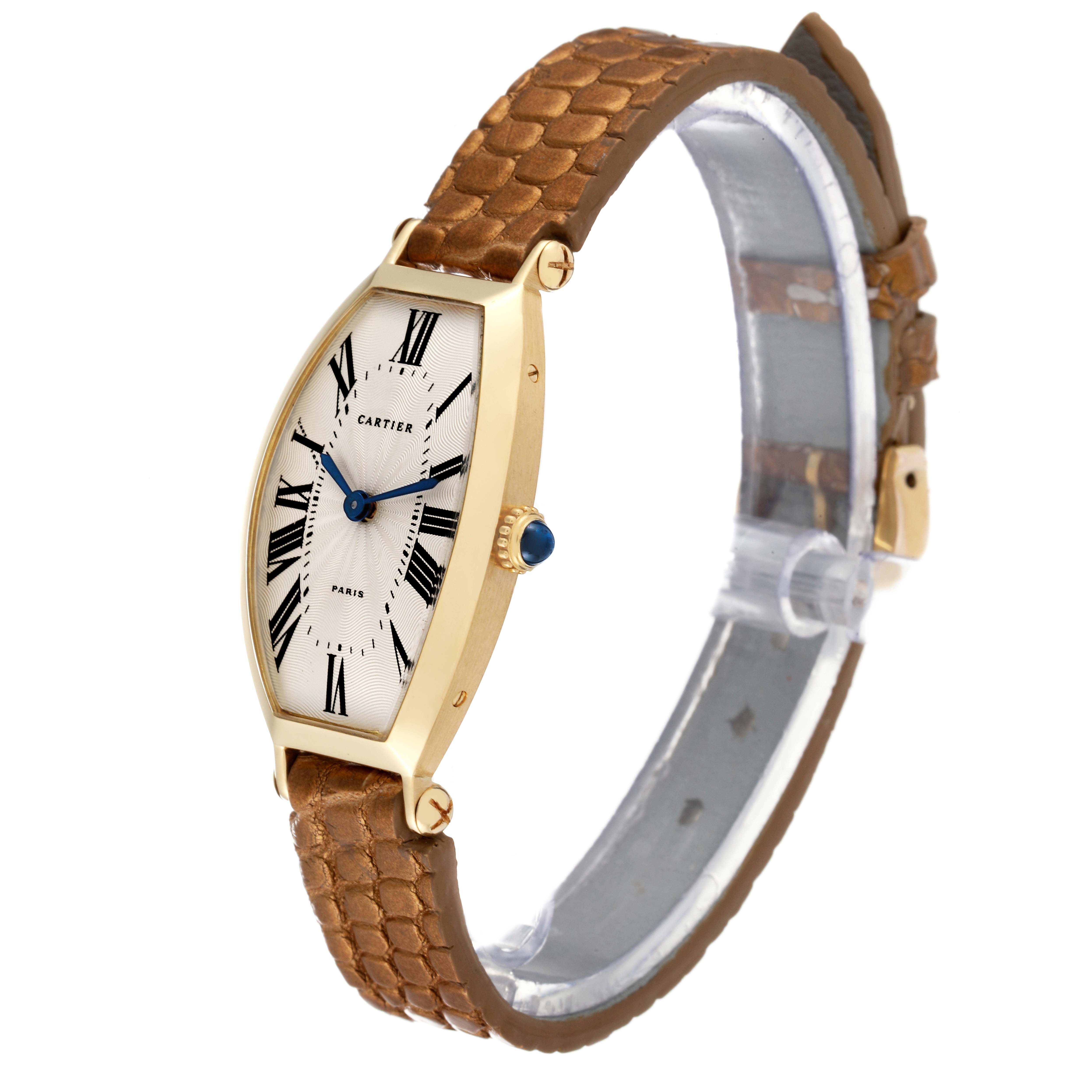 The image shows a side and frontal view of a Cartier Tonneau Women's Yellow Gold Silver Dial Women's Yellow Gold Silver Dial model watch with a brown leather strap.
