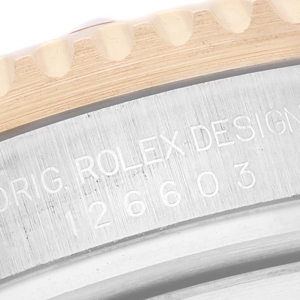 This image shows a close-up of the engraved bezel and case edge of the Rolex Sea-Dweller 126603 Men's Steel and Gold (two tone) Black Dial 126603 Men's Steel and Gold (two tone) Black Dial watch.