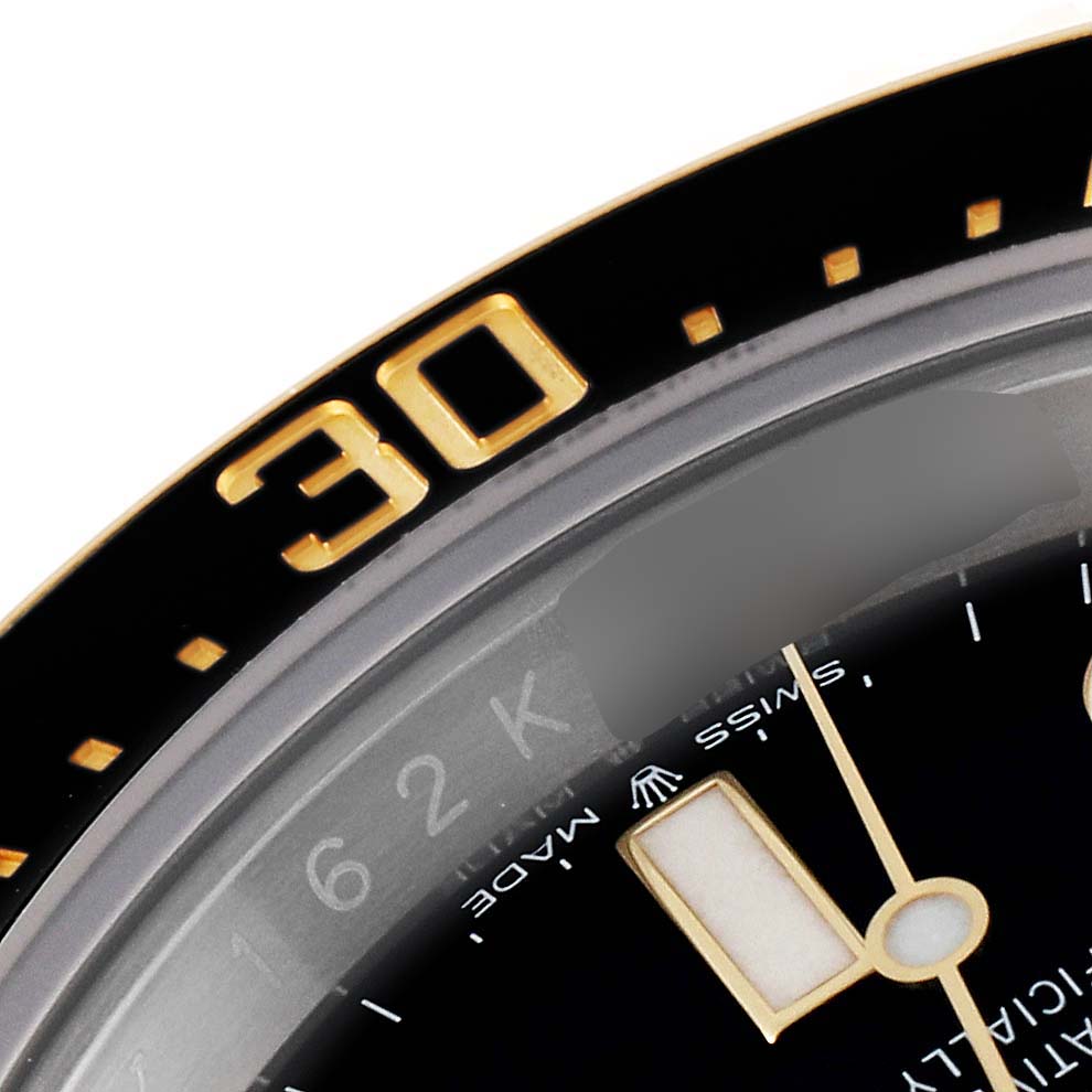 This image shows a close-up of the bezel and part of the dial of a Rolex Sea-Dweller 126603 Men's Steel and Gold (two tone) Black Dial 126603 Men's Steel and Gold (two tone) Black Dial watch.